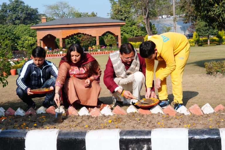 Chief Minister plants tulip bulbs with his family