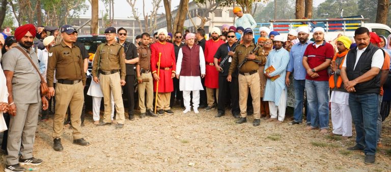 Devotees carry 94-foot-tall new Flagpole to Guru Ram Rai Darbar